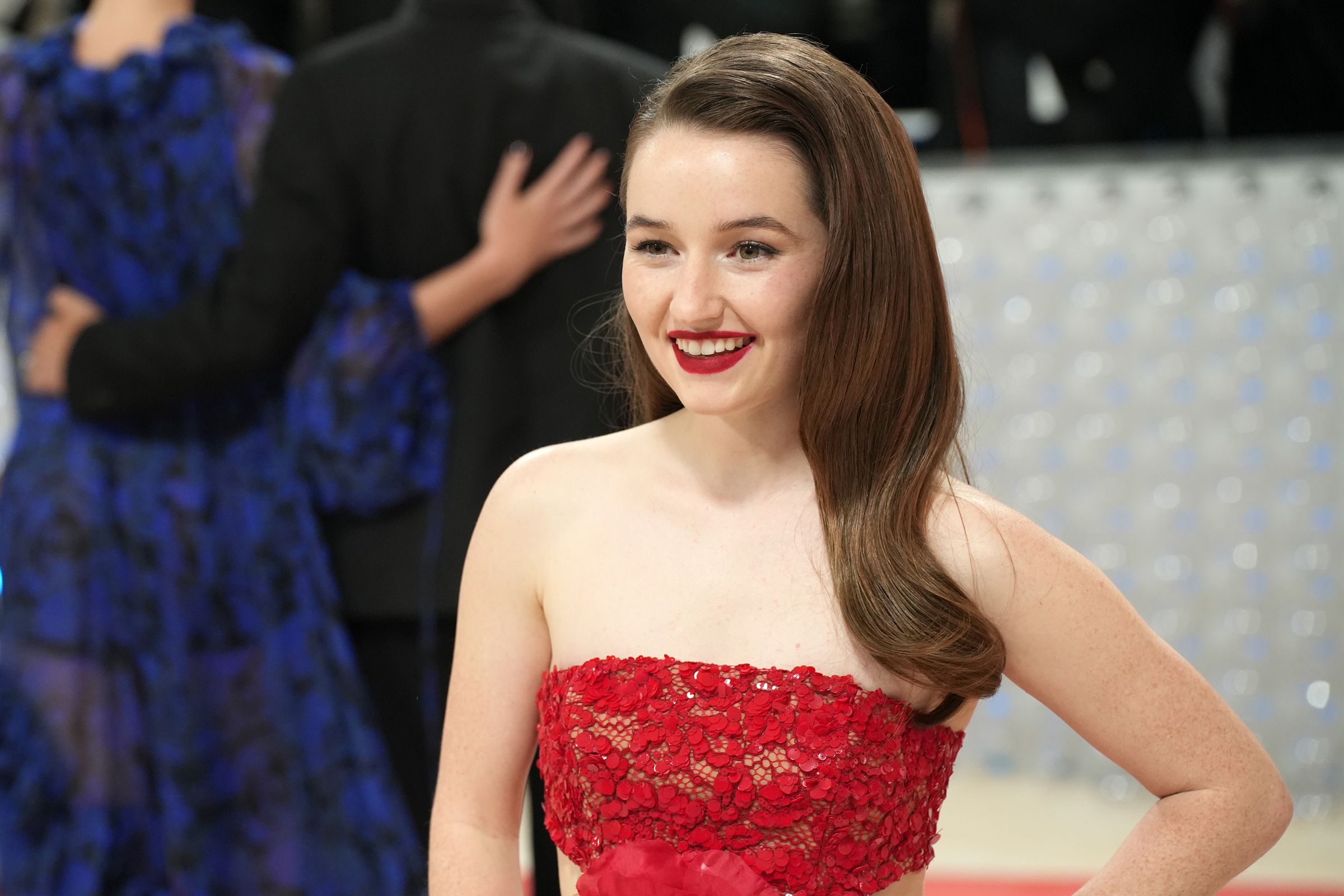 A photo of Kaitlyn Dever in a red dress