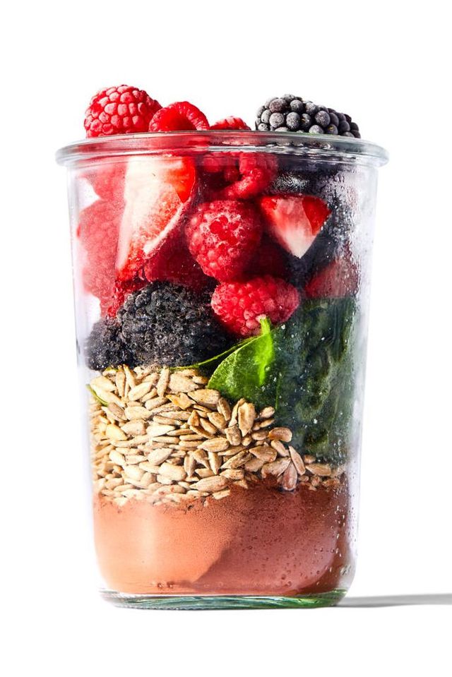 a glass bowl with a bowl of cereal and strawberries