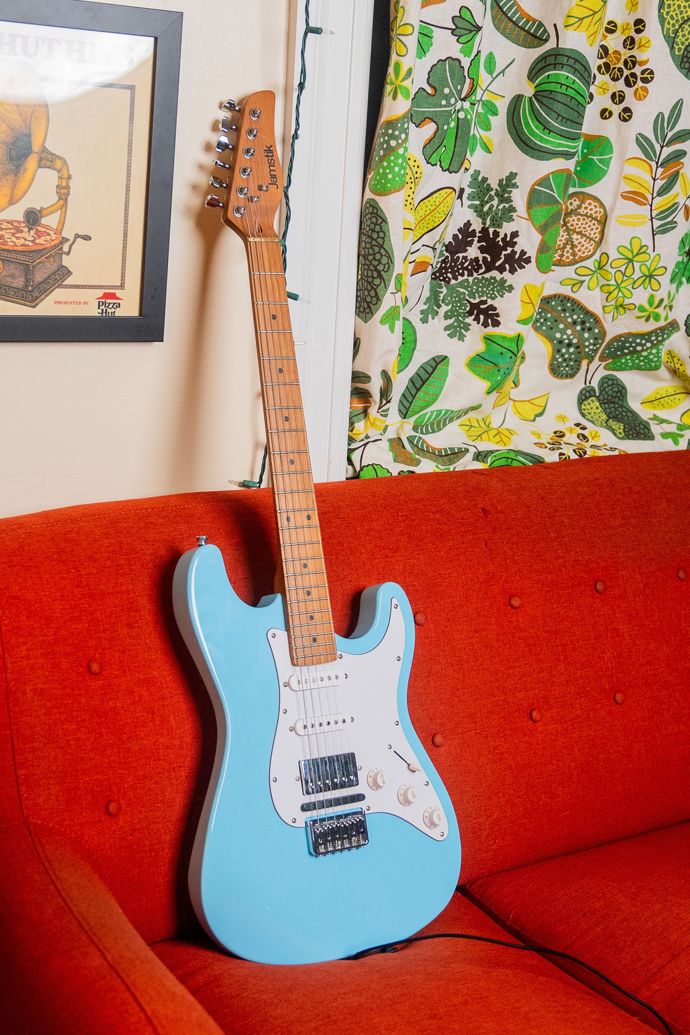 The Jamstik Classic upright on the couch.