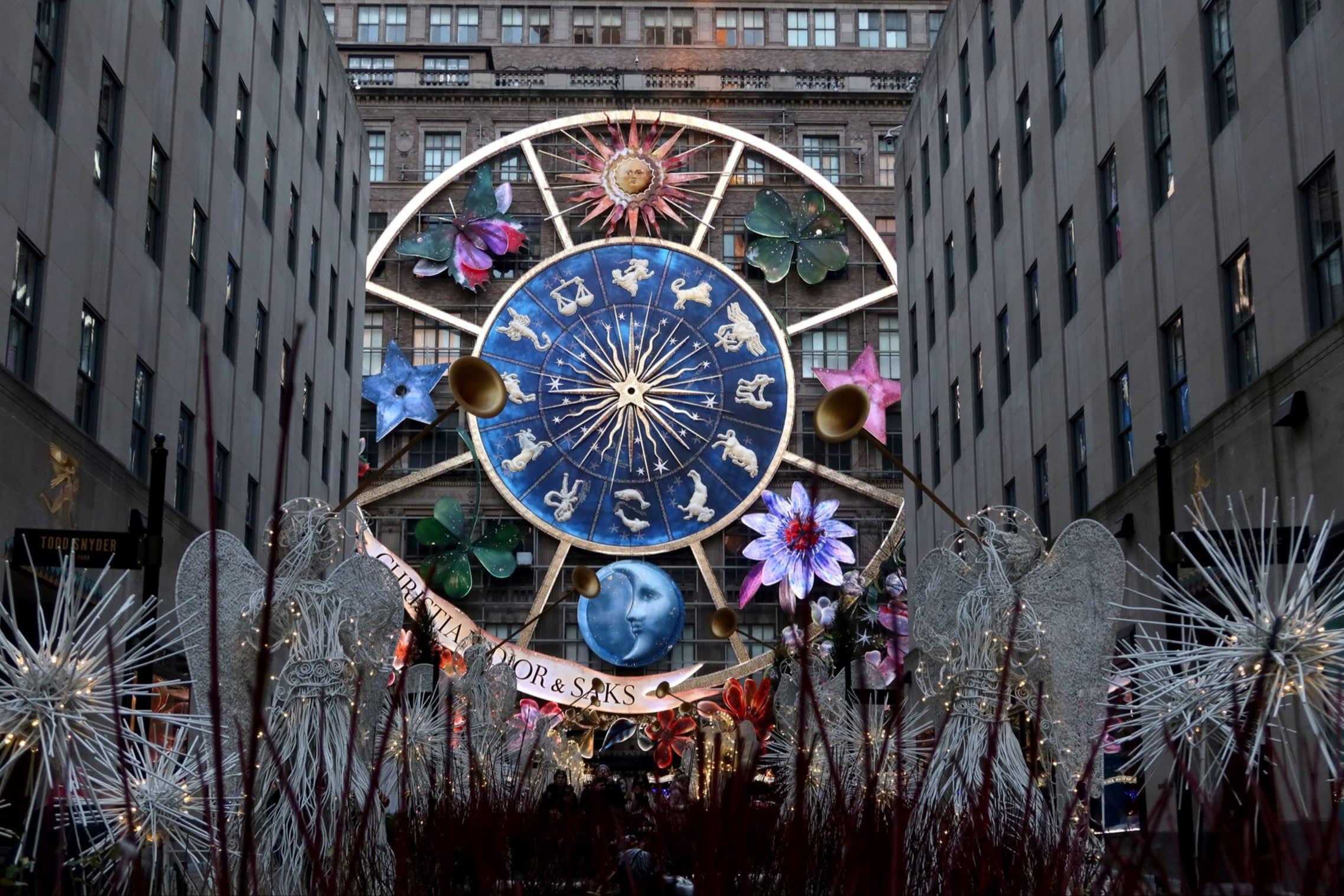 A colourful carousel of star signs and flowers on the front of a building