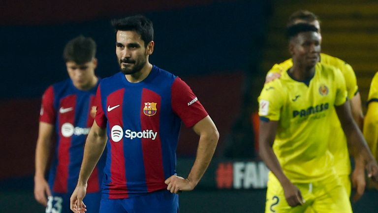 Barcelona players, left, react after Villarreal's Jose Luis Morales scoring his side's fifth goal during a Spanish La Liga soccer match between Barcelona and Villarreal at the Olimpic Lluis Companys stadium in Barcelona, Spain, Saturday, Jan. 27, 2024. (AP Photo/Joan Monfort)