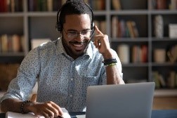 A man with a headset and microphone, engaging in a virtual meeting.