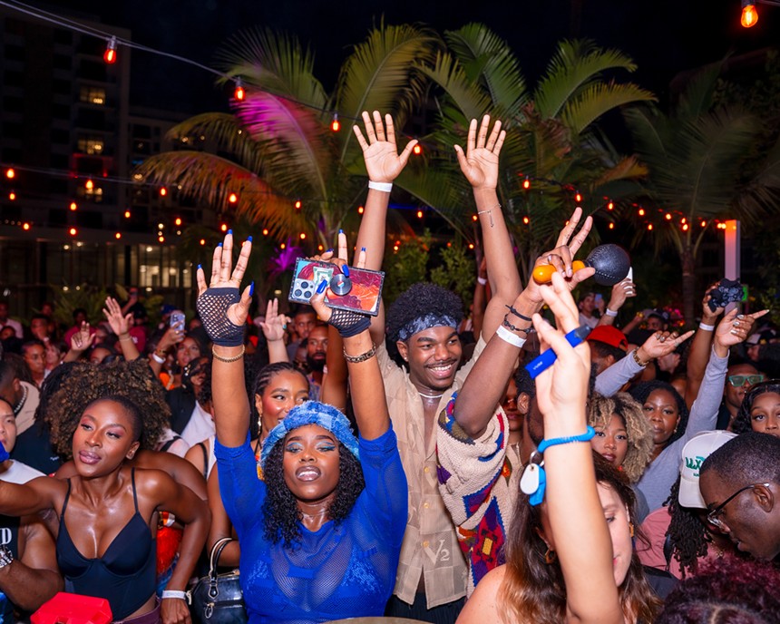 Partygoers dance and celebrate at a Stamped event