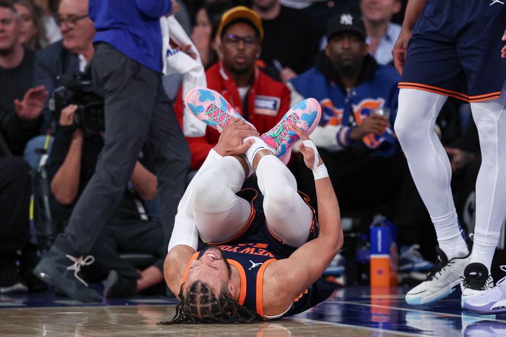 Jalen Brunson lying on the ground after being injured during a basketball game between the New York Knicks and Memphis Grizzlies.