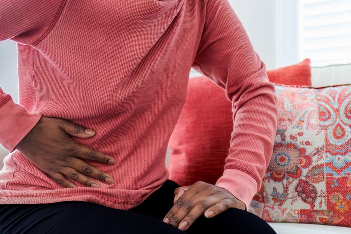 Woman holding her stomach.