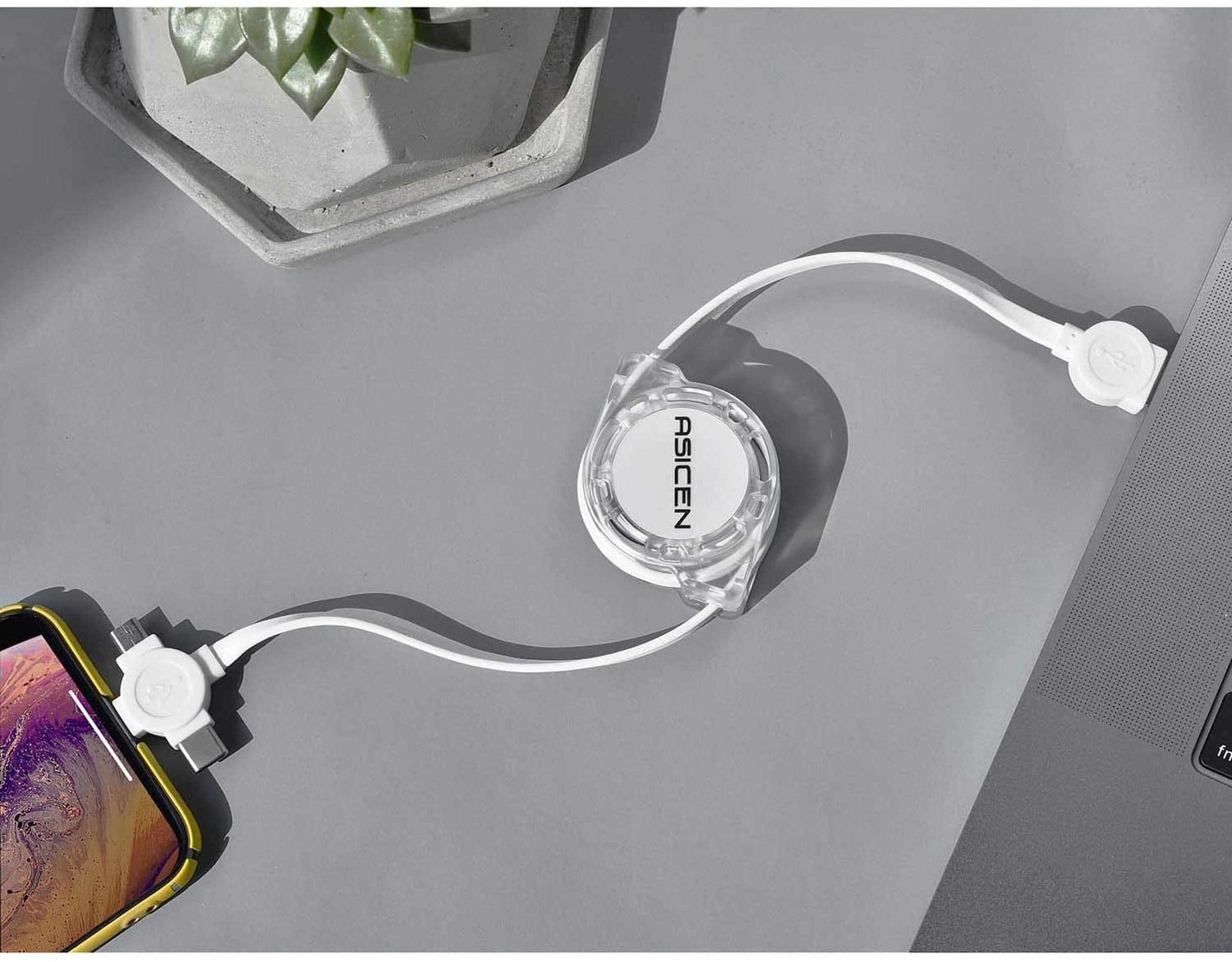 The Asicen retractable 3-in-1 charging cable plugged into a phone and laptop.