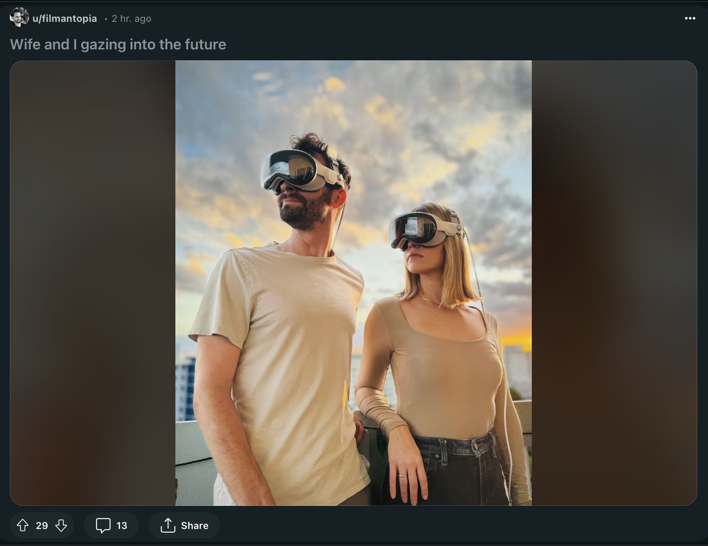 A man and a woman standing outside, looking to the side, with a cloudy sky behind them at sunset.