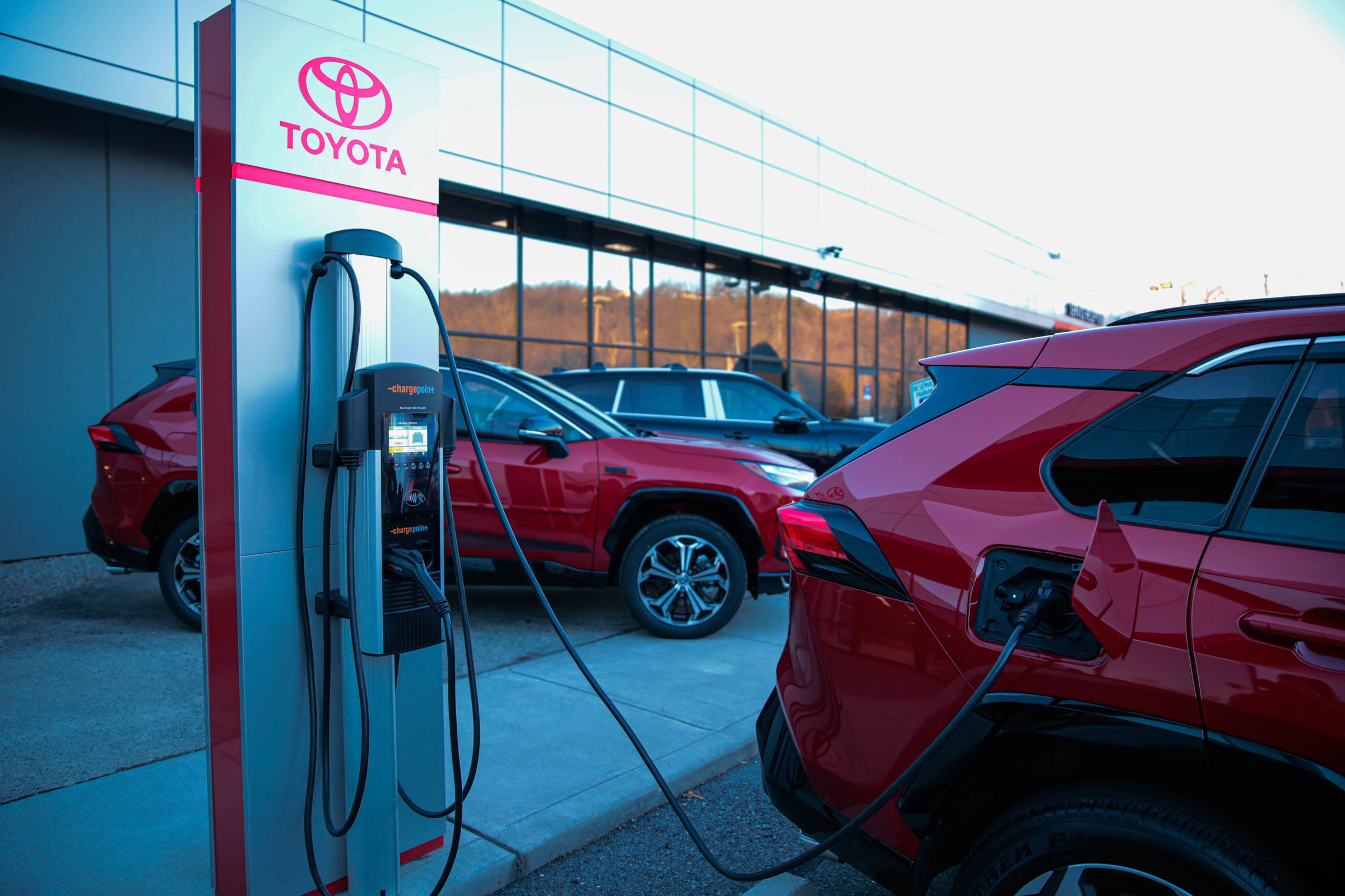 A picture of a Toyota vehicle plugged into a Toyota charging station.