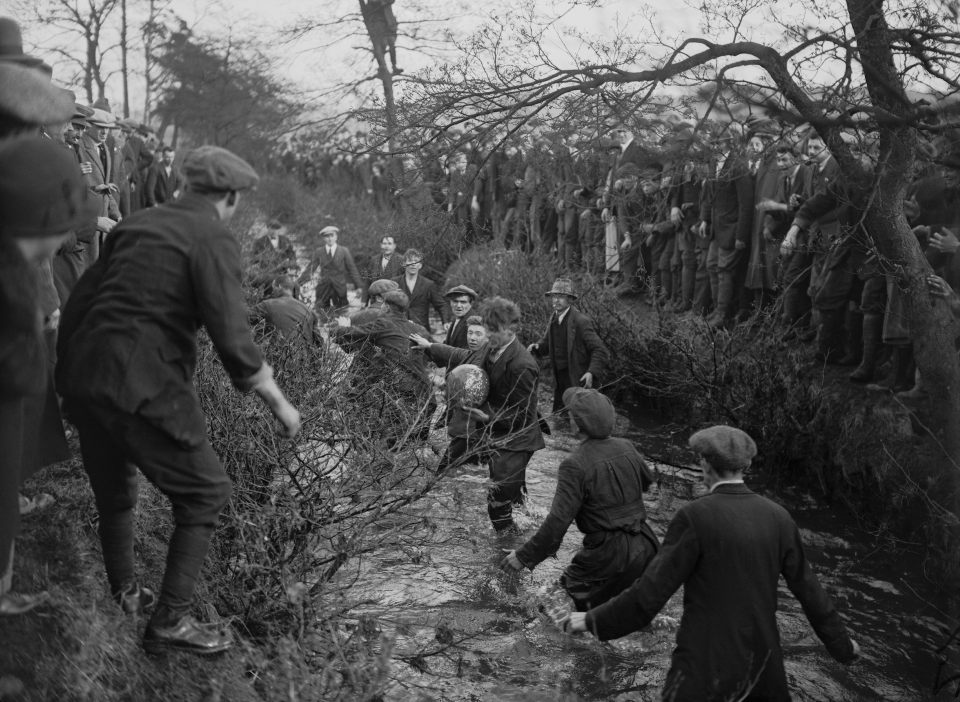 Players tussling for the ball in the river during the 1926 match. (E. Bacon/Topical Press Agency/Hulton Archive/Getty Images)