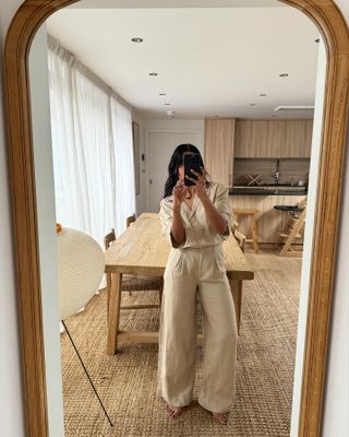 Monikh takes photo in mirror wearing matching linen set