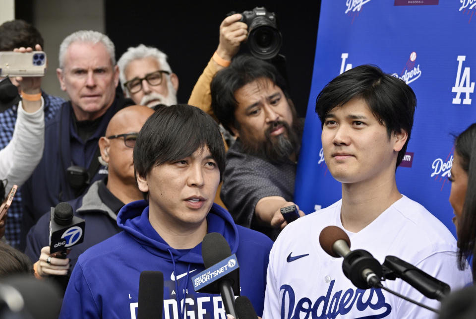 Los Angeles, CA - February 03:  Shohei Ohtani, right, of the Los Angeles Dodgers speaks to the media with the help of his interpreter Ippei Mizuhara during DodgerFest a celebration of the upcoming season with live entertainment, behind-the-scenes experiences, food, drinks and meeting the newest Dodgers at Dodger Stadium in Los Angeles on Saturday, February 3, 2024. (Photo by Keith Birmingham/MediaNews Group/Pasadena Star-News via Getty Images)