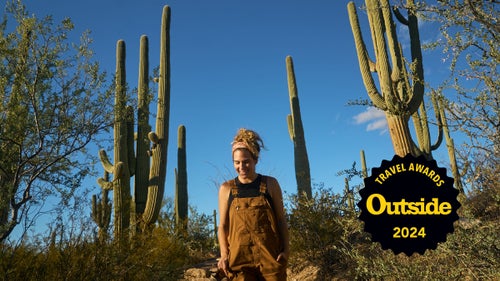 A women walks down a desert trail at Arizona’s Saguaro National Park.