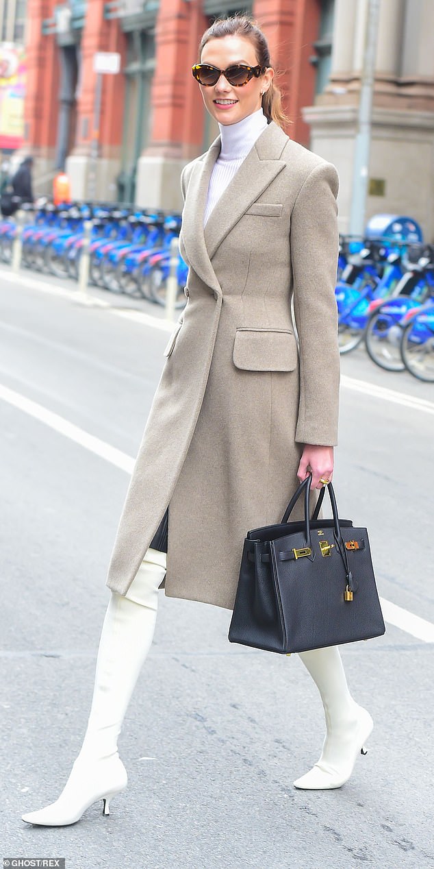 Model Karlie Kloss was snapped walking around Soho with her simple black Birkin bag - which is available for re-sale for around $20,000