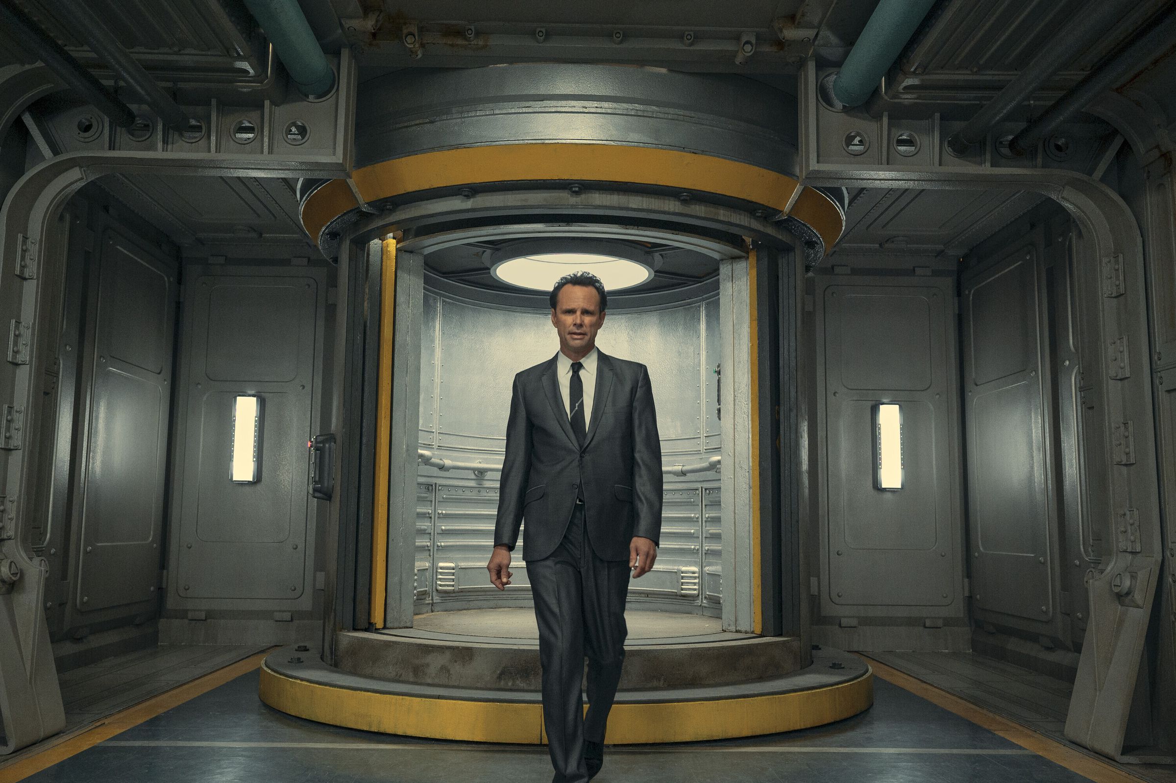 Screenshot from the Fallout TV series featuring Walton Goggins as Cooper Howard, a Hollywood actor in a commercial selling living spaces in a Vault-Tec vault.