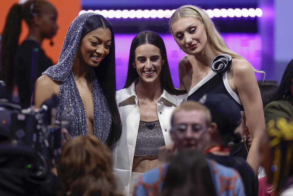 From left, LSU's Angel Reese, Iowa's Caitlyn Clark, and Stanford's Cameron Brink, pose for a photo before the start of the WNBA basketball draft, Monday, April 15, 2024, in New York. (AP Photo/Adam Hunger)