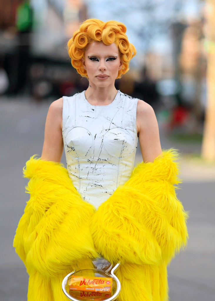 Julia Fox with Velveeta yellow hair and giant yellow coat