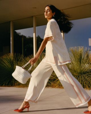 Model wearing a Calle Del Mar white knit pant set