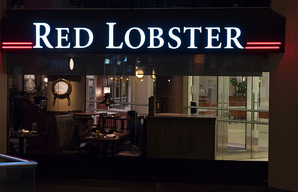 Red Lobster's restaurant entrance sign light up at night.