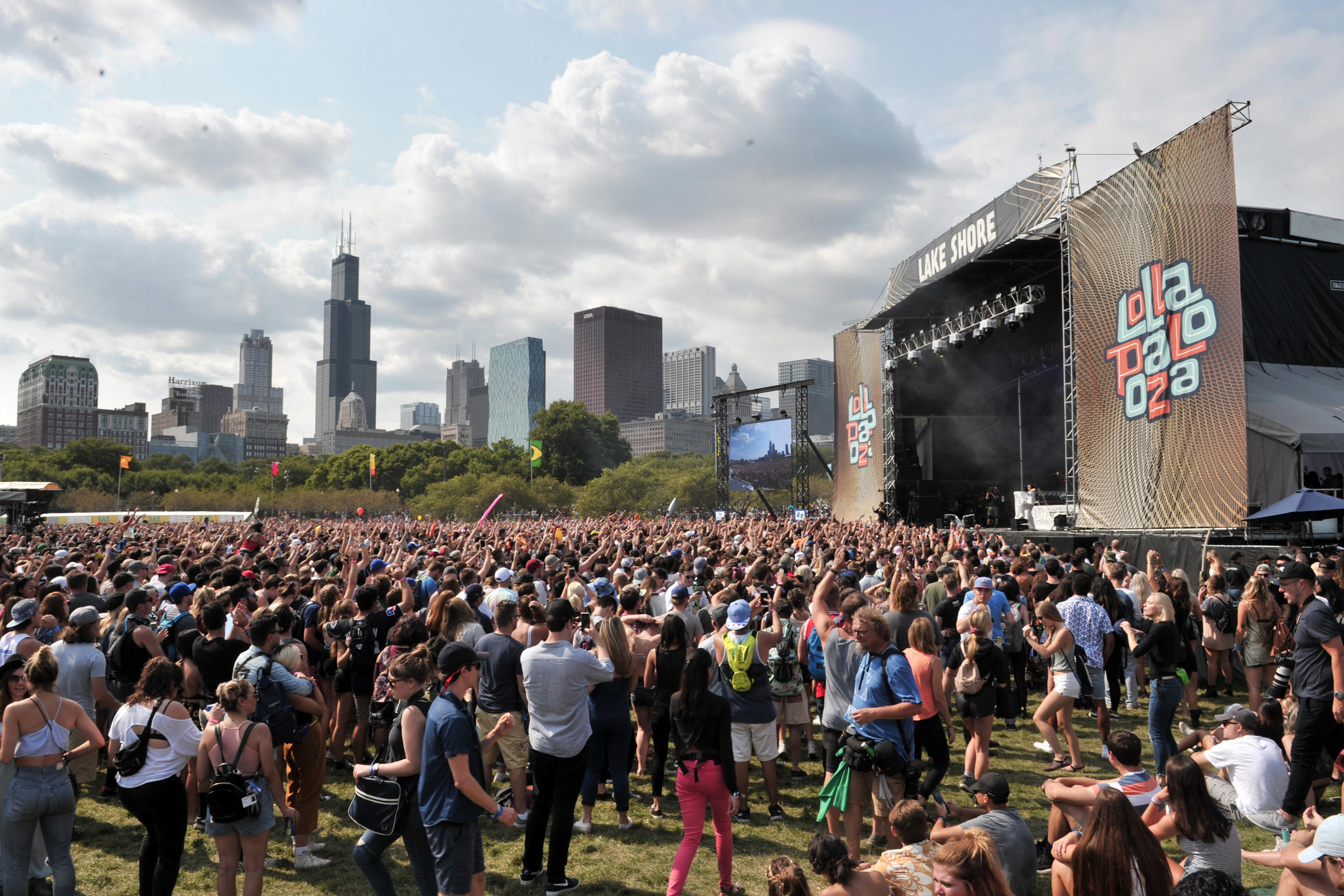 Fans watch as Charli XCX performs at Lollapalooza in 2017.