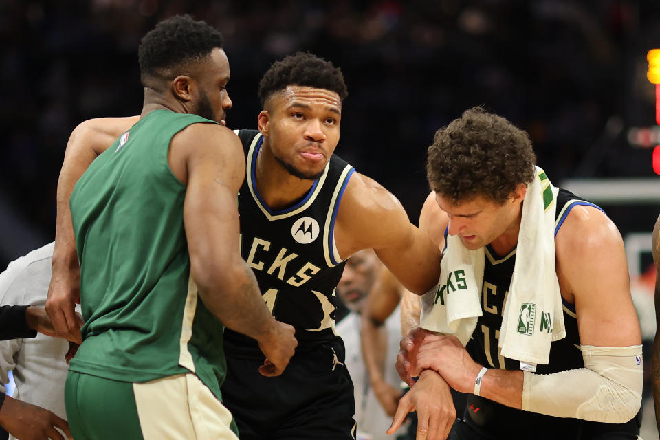 MILWAUKEE, WISCONSIN - APRIL 09: Giannis Antetokounmpo #34 of the Milwaukee Bucks is helped off the court by Thanasis Antetokounmpo #43 and Brook Lopez #11 after suffering an injury during the second half of a game against the Boston Celtics at Fiserv Forum on April 09, 2024 in Milwaukee, Wisconsin. NOTE TO USER: User expressly acknowledges and agrees that, by downloading and or using this photograph, User is consenting to the terms and conditions of the Getty Images License Agreement. (Photo by Stacy Revere/Getty Images)