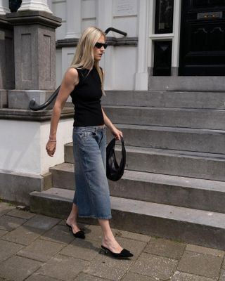 Woman wearing jeans and a black tank top