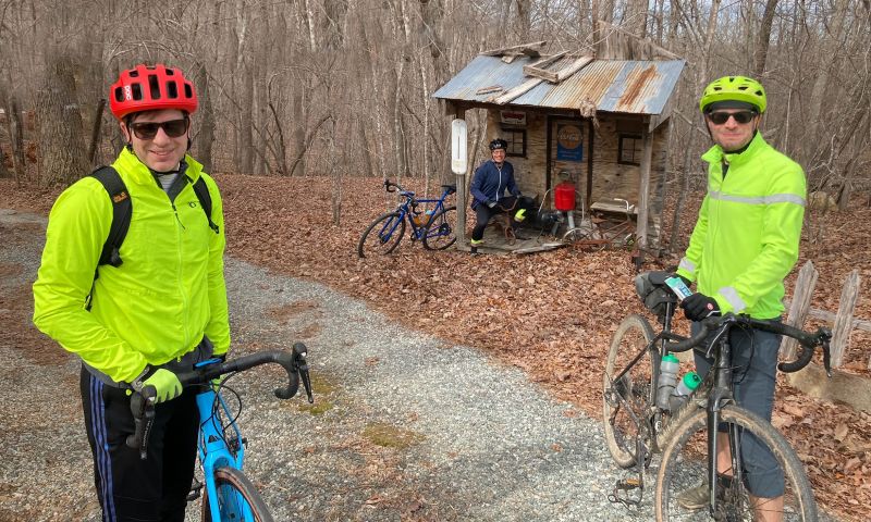 Rob Rolfe, Chris Polage and Nick Turner rest with their bicycles in the midst of a cycling outing.