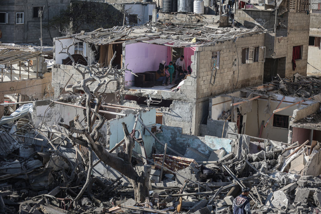 Palestinians inspect their destroyed homes...