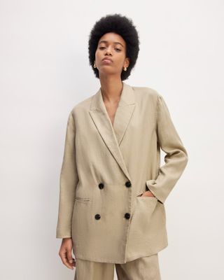 a model wears a khaki double-breasted blazer