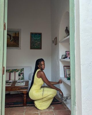 Chrissy Rutherford wearing a crochet yellow dress.