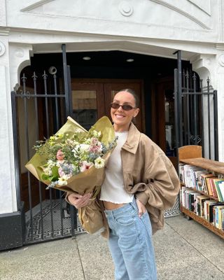 emma leger wearing khaki jacket and blue jeans