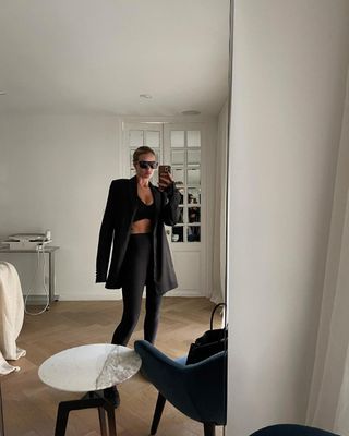 @rosiehw wearing leggings and a blazer