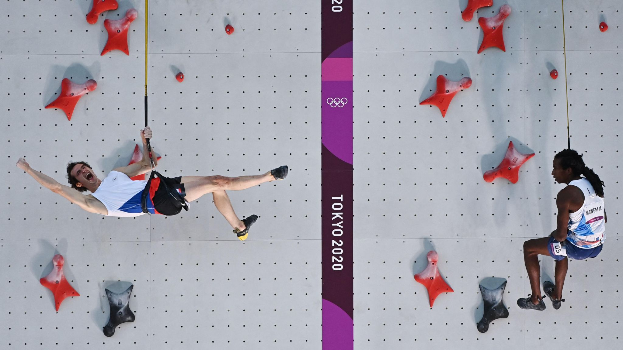  Czech Republic's Adam Ondra (L) celebrates beating France's Mickael Mawem in their men's sport climbing speed finals