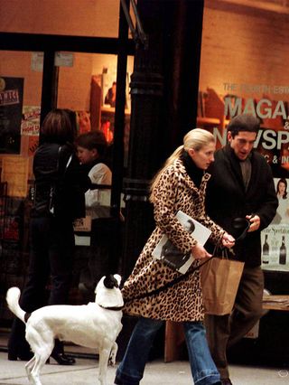 CBK on a walk wearing leopard-print coat and jeans