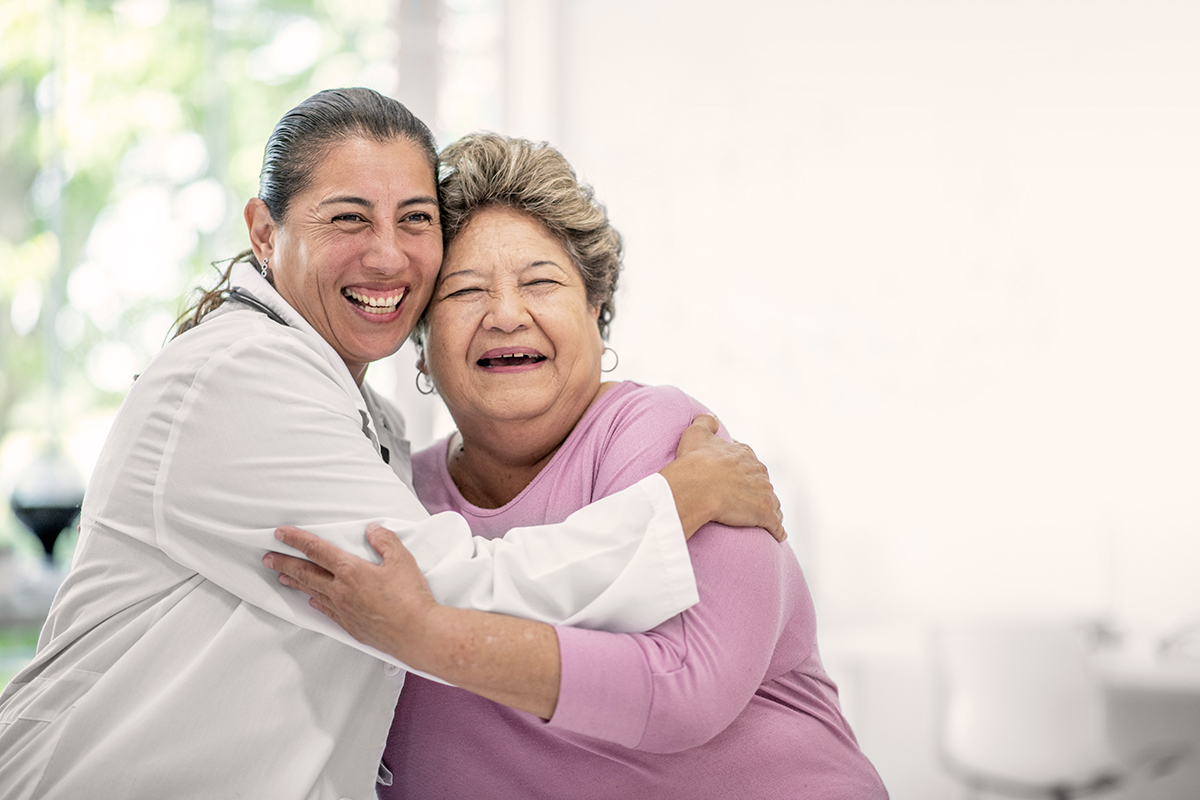 Woman hugging her female doctor