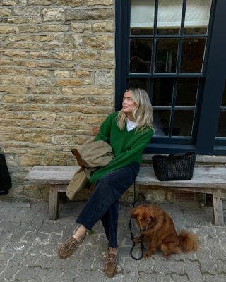 Woman in jeans, boat shoes, and sweater