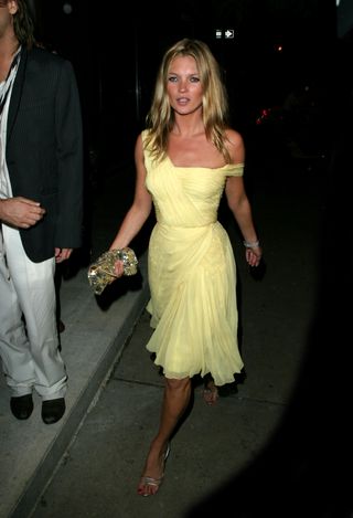 Kate Moss wears a yellow dress.