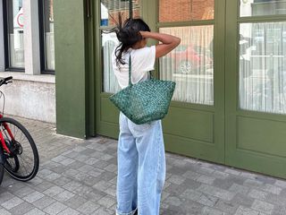 Woman standing in the street with a Dragon Diffusion bag