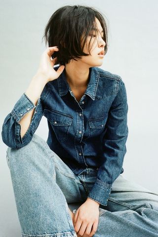 a model wears a denim shirt