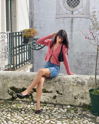 Girl wearing cardigan and denim shorts