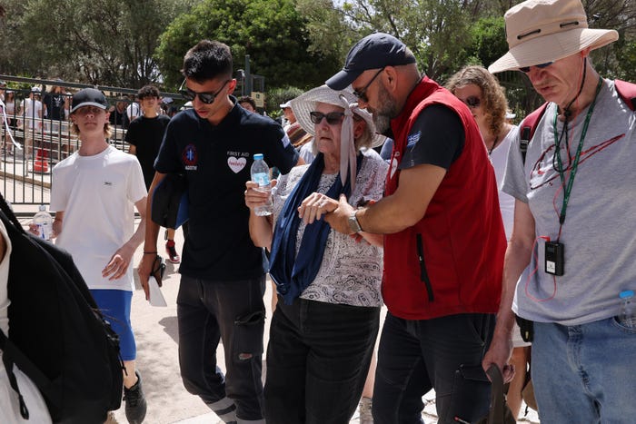 Rescuers attending to an older woman.