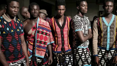 Getty Images Models in clothes by fashion designer Laduma Ngxokolo wait backstage before a show in Cape Town, South Africa - archive shot