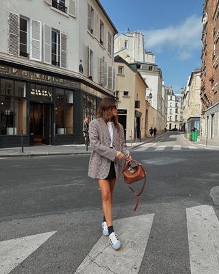 @kimturkington_ wearing Gazelle trainers with a mini skirt and blazer