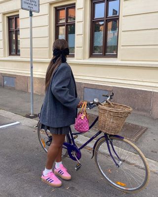 @nnennaechem wearing pink trainers with a blazer and skirt