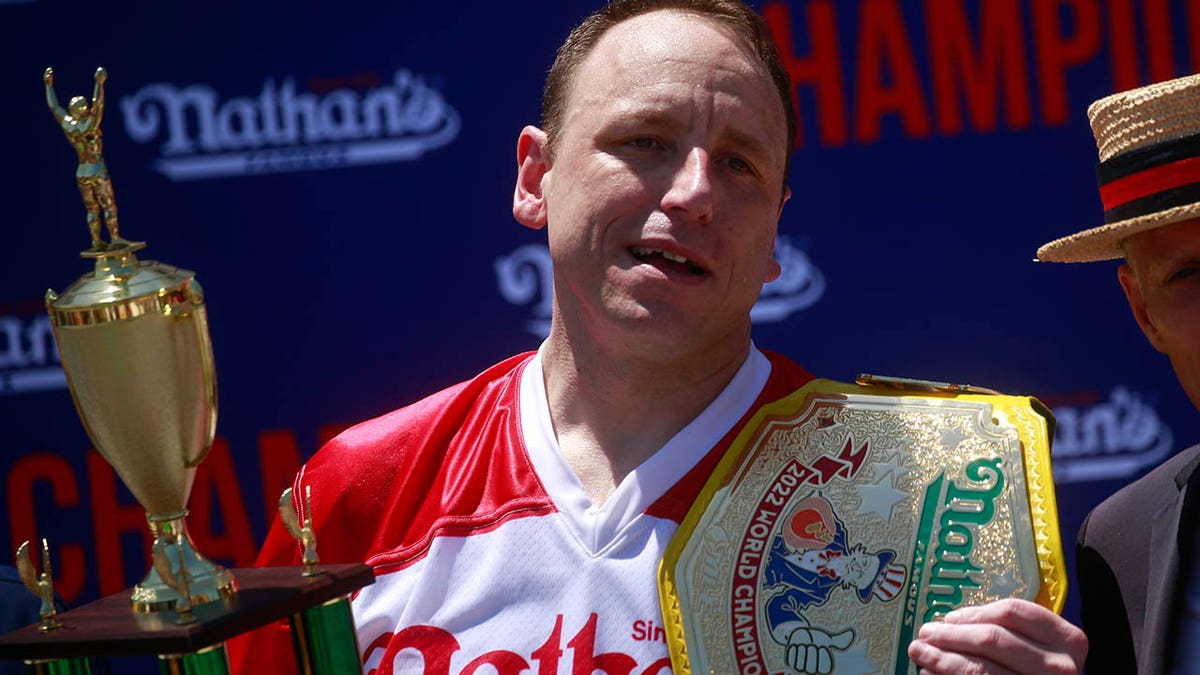 Joey Chestnut holds his belt