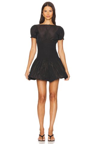 a model wears a black short-sleeve dress with a bubble hem