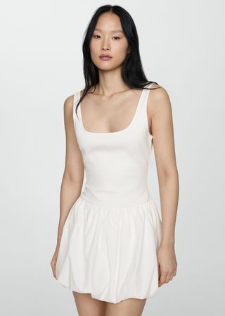 a model wears a white tank dress with a bubble hem