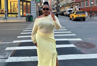 @aniyahmorinia wearing yellow sweater, yellow satin skirt, walking down the street in NYC