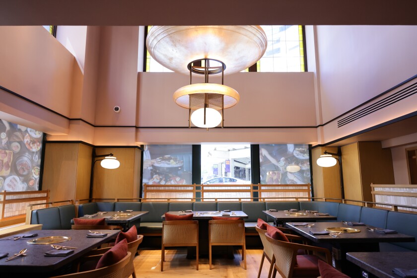 Restaurant seating with grills in the center of tables at Perilla, a Korean steakhouse opening at L7 Chicago by Lotte this summer.