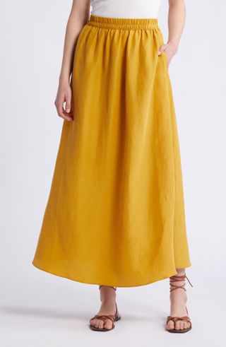 a model wears a marigold yellow A-line midi skirt