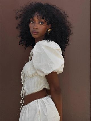 Content creator Emmanuelle Koffi in a white linen set